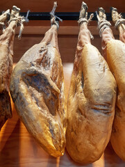 Close-up of hanging Iberian ham legs. Hind legs of an Iberian pig. Spanish and gourmet cuisine.