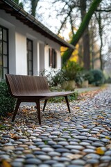 Wooden bench near building on a stone-paved path