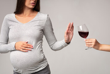 No Alcohol. Unrecognizable Pregnant Lady Gesturing Stop To Offered Glass Of Wine Standing Over Gray...
