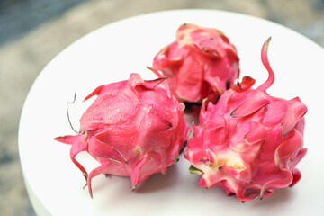 Delicious pitaya fruits on white table outdoors, closeup