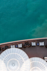 Top view of sea and water of sailing ship. Lounge promenade deck on cruise liner, vertical photo. 