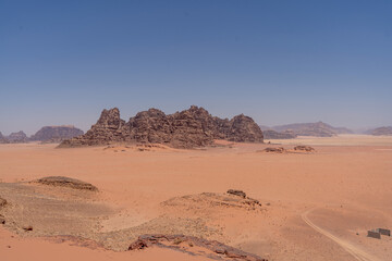 Sand dunes and desert landscapes with mountains and clear sky