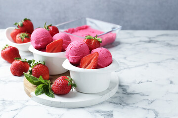 Refreshing sorbet, strawberries and mint on white marble table against grey background, closeup