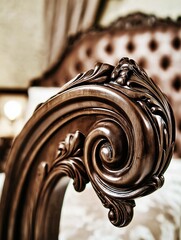 Ornate wooden furniture detail showcasing intricate carvings and rich textures, highlighting craftsmanship and elegance in a luxurious interior setting with a vintage aesthetic