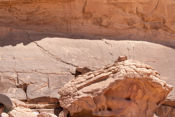 Ancient Carvings in the Desert: Captivating image reveals ancient rock carvings on the sandstone walls, depicting stories from a bygone era, offering a glimpse into history and ancient civilizations.