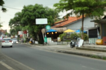Blurred view of road with cars in city