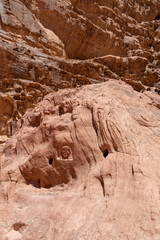Ancient Rock Carving: A captivating sandstone rock face, meticulously sculpted with historical...