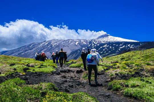 Hikers on Mount Etna Against a Dramatic Landscape