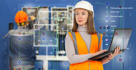 Female engineer in safety vest and helmet checks electrical blueprint on laptop, background shows...
