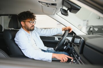 Arab Customer testing new car features in dealership showroom