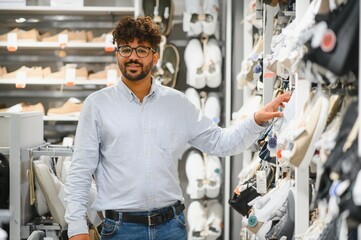 Arab customer choosing shoes in fashion store