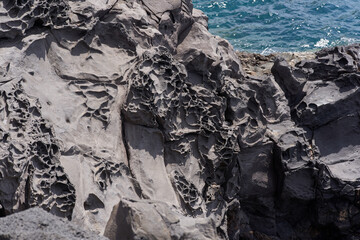 Textured volcanic rock by the sea
