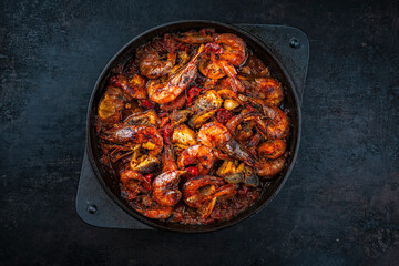 traditional artisan homemade gambas prawn und fish stew cajun gumbo in cast-iron skillet