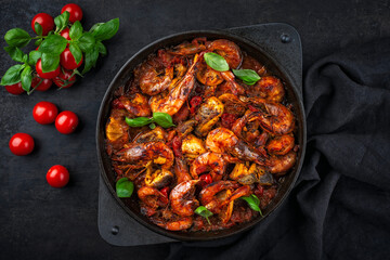 Traditional artisan homemade gambas prawn and fish stew cajun creole gumbo served as top view on a cast-iron skillet
