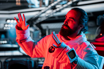 Astronaut raises hand defensively after triggering red light motion alert near restricted zone....