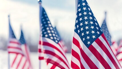 A close up view of several american flags waving gently in the wind on a bright day