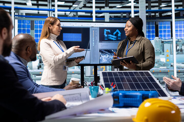Engineers and scientists collaborate on solar panel research and development, analyzing data and...