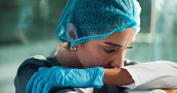 Upset, doctor and woman in hospital with stress in hallway for patient loss, mistake and medical crisis. Healthcare, surgeon and sad person on floor with burnout, bad news and pressure in surgery