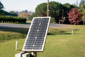 Small solar panel generating renewable energy in public park