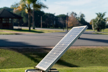 Small photovoltaic panel capturing sunlight in a park, providing sustainable and clean energy
