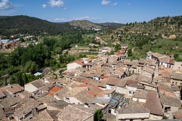 Historic town of Valderrobres seen from castle ramparts, with river Matarraña, rooftops and...