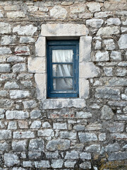 Blue window on stone wall background