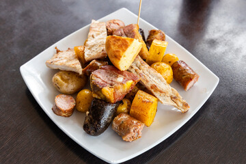 Traditional boyacense food - Roasted meats, chorizo, longaniza, arepas, plantains, and potatoes