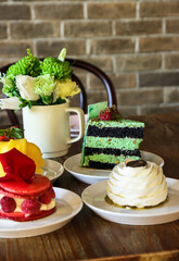 Bakery Café Pastries Desserts Display on Table - Pistachio Chocolate Cake Cream Tarts Raspberry Macaron