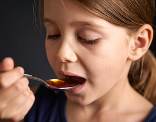 Sick Child Taking a Spoon Full of Medicine 82