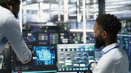 Pleased data center manager praising work done by engineer using neural network models to configure...