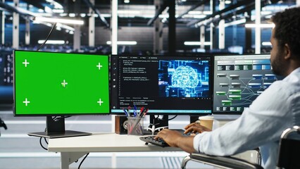 Data center engineer with paraplegia using AI deep learning algorithms on green screen PC to...