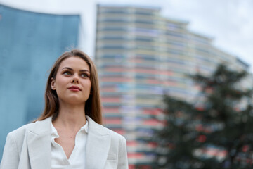 Confident woman in business attire outdoors, exuding professionalism amidst modern architecture,...