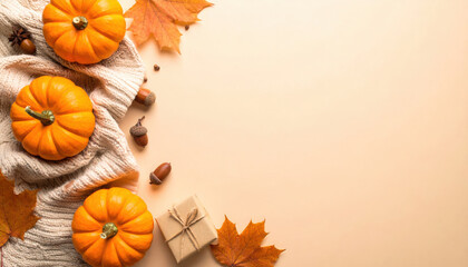 Pumpkin, autumn leaf, acorn, cozy blanket, and gift box on beige background create warm, festive fall atmosphere, perfect for Thanksgiving or seasonal celebration
