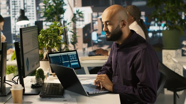 Jolly bookkeeper at work happy after finally finishing reading and verifying business documents. Cheerful employee pleased after finishing analyzing company information records, camera A