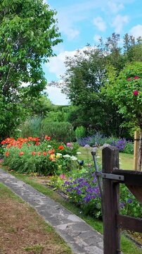 Hampshire England UK. 08.06.2025. Video. Five bar gate looking into a Hampshire English country garden. Early summer,