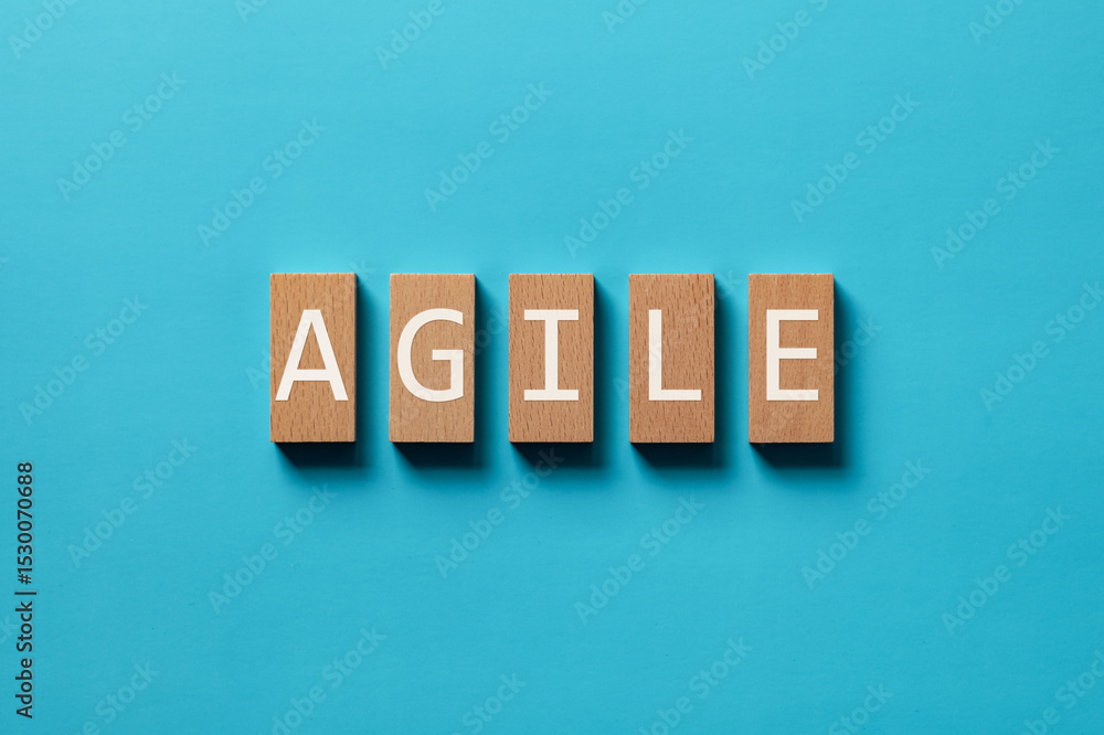 Poster there is wood block with the word agile. it is as an eye-catching image.