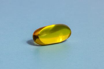 Fish Oil Capsule Closeup on a Blue Background