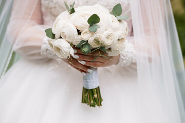 Bridal Bouquet of White Ranunculus with Eucalyptus, Wedding Florals Held by Bride in Pale Dress, Soft Romantic Style