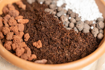 Organic potting soil mix with clay pebbles, coco coir, pumice and akadama for indoor plants,...
