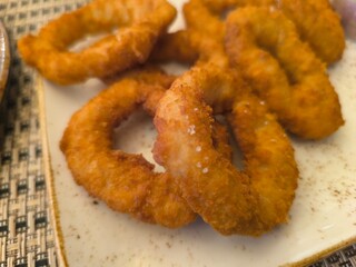 Close-up of baked squid rings in plate on table