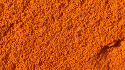 Vibrant orange powder texture background spice