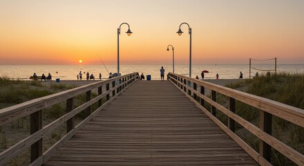 Fototapeta premium Wooden boardwalk leading to the beach during a vibrant sunset with people enjoying the coast
