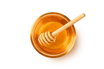 Glass of honey with honey dipper isolated on white background. Top view
