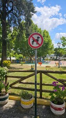 No Dogs Allowed Sign at Colorful Children’s Playground in Public Park