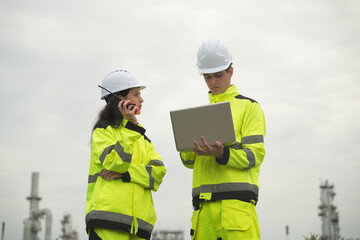 Engineers discuss project details at construction site during cloudy afternoon