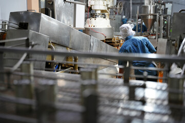 Worker operating machinery in a food processing plant during the daytime hours