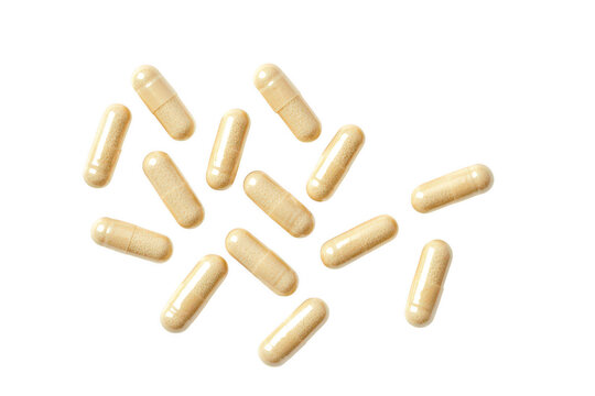 Collection of beige dietary capsules scattered isolated on transparent background
