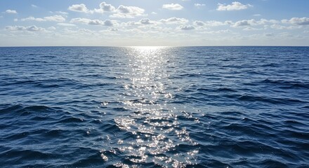 Fototapeta premium Beautiful sunlit ocean surface with shimmering light reflecting on the water's surface