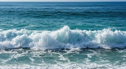 Fototapeta premium Beautiful ocean waves crashing creating white foam against a backdrop of blue water