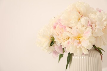 Bouquet of beautiful peonies on white background, closeup. Space for text